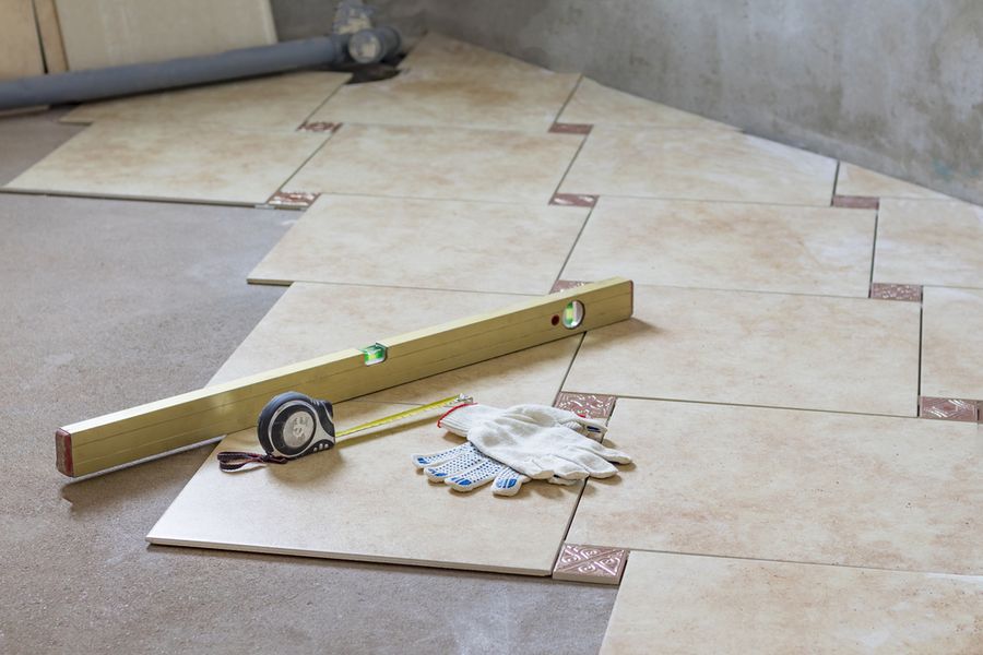 Floor tiles set out with a level and hand tools during installation