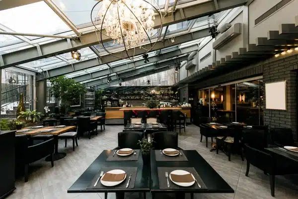 Restaurant dining room under a glass roof