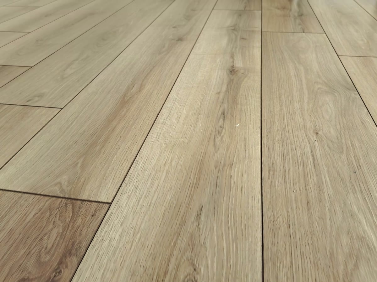 Finished light oak floor running across a room